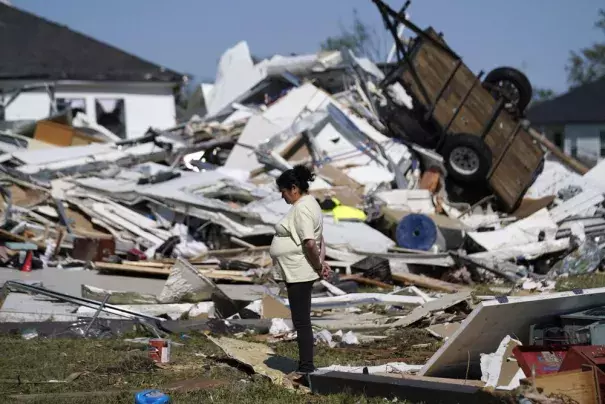 Bertelina Martinez, who lives nearby and her son lives across the street, looks over destruction after a tornado struck the area in Arabi, La., Wednesday, March 23, 2022. (Credit: AP Photo/Gerald Herbert)