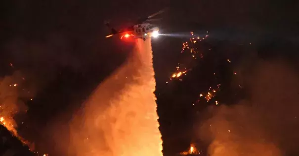 Thousands have been forced to evacuate their homes as a wildfire threatens the Santa Clarita Valley, north of Los Angeles. A resident describes being evacuated as firefighters worked to save his neighborhood. Photo by Ringo H.W. Chiu/Associated Press.