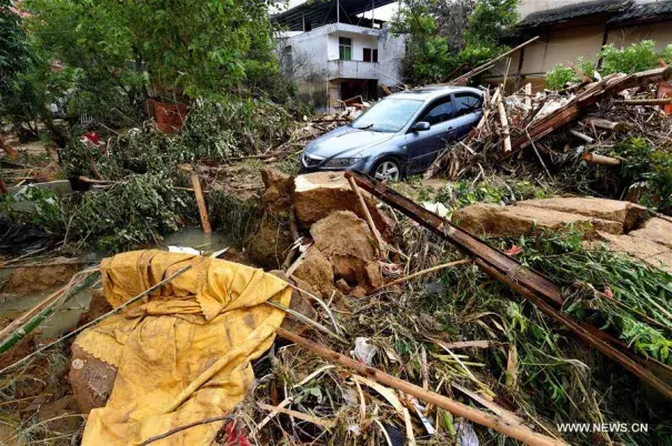 A car is buried in messes at Bandong Township after flooding in Minqing County, southeast China's Fujian Province, July 11, 2016. Photo: Zhang Guojun / Xinhua
