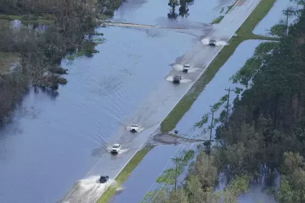 FILE - Cars drive on a flooded street caused by Hurricane Ian Thursday, Sept. 29, 2022, in Fort Myers, Fla. After months of gradually warming sea surface temperatures in the tropical Pacific Ocean, NOAA officially issued an El Nino advisory Thursday, June 8, 2023, and stated that this one might be different than the others. (Credit: AP Photo/Marta Lavandier, File)