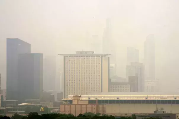 The Marriott Marquis, left, and the Hyatt Regency McCormick Place, center, stand above The McCormick Place Convention Center in a veil of haze from Canadian wildfires obscuring the majestic Chicago skyline, as seen from the city’s Bronzeville neighborhood Tuesday, June 27, 2023, in Chicago. (Credit: AP Photo/Charles Rex Arbogast)