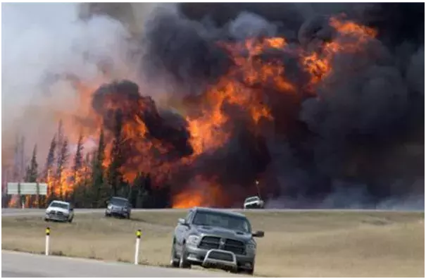 In this May 7, 2016 file photo, a wildfire burns south of Fort McMurray, Alberta. A dry and blistering hot northern Alberta is burning and doing so unusually early in the year, but that’s only the latest of many gargantuan fires on an Earth that’s grown hotter with more extreme weather. Photo: Jonathan Hayward, The Canadian Press, AP