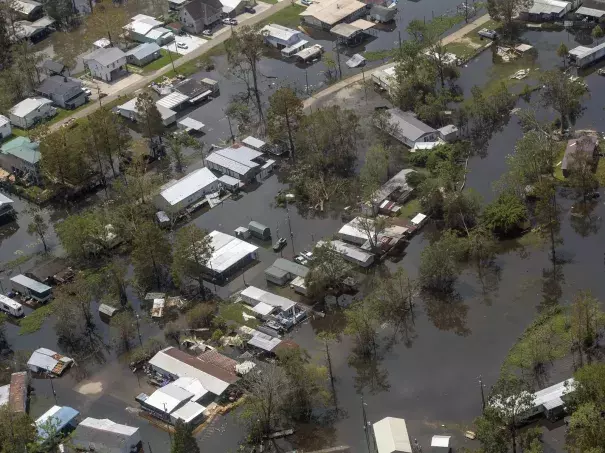 Heavy rain and storm surge from Hurricane Ida caused flooding from Louisiana to New England in September 2021. Homes in the town of French Settlement, La., were still underwater four days after the storm made landfall. Climate change is driving more flood risk in the U.S. (Credit: Bill Feig/AP)