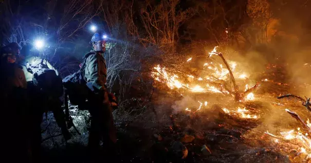 Firefighters build a fire line during the Blue Cut Fire in California's San Bernardino County in August. Photo: Patrick T. Fallon, Zuma