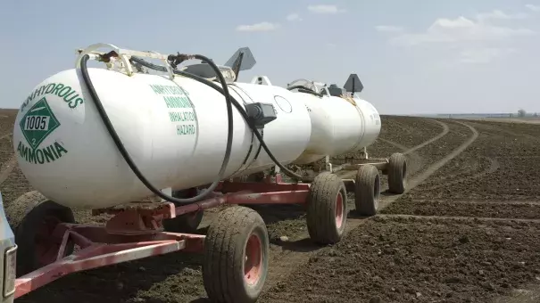 Anhydrous ammonia tanks in a newly planted wheat field. Walmart has promised big cuts in emissions of greenhouse gases. To meet that goal, though, the giant retailer may have to persuade farmers to use less fertilizer. It won't be easy. Photo: TheBusman / Getty Images