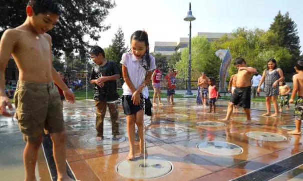 Erika Jurarez, 6, center, and her brother Emilio Juarez, 9, play in the spray ground at Prince Gateway Park, in Santa Rosa on Friday, September 1, 2017. Photo: Christopher Chung, The Press Democrat