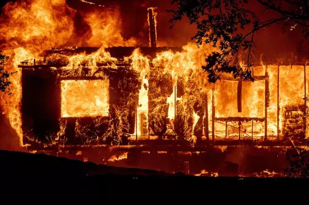 Flames consume a home as the Kincade Fire tears through the Jimtown community of Sonoma County, Calif. Credit: Noah Berger/AP