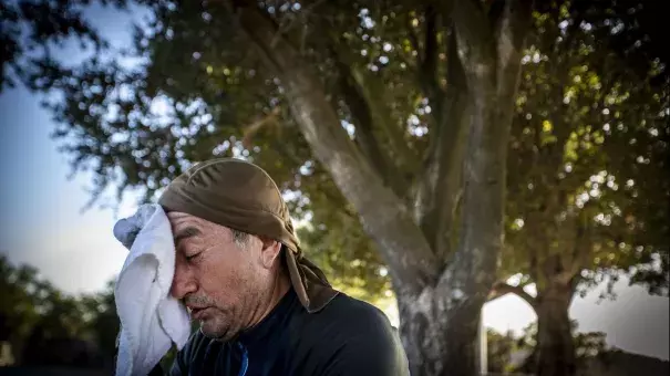 Facing temperatures in the 90s, Guillermo Salazar of Reseda takes a break from mountain biking at San Vicente Mountain Park in Los Angeles last month. Credit: Allen J. Schaben, Los Angeles Times