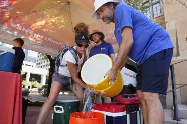 Volunteers are shown preparing heat kits in Phoenix.