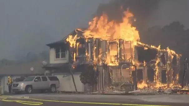 A local firefighter and resident react to the wildfires that have effected thousands of Californians across eight counties in Northern California. Photo: AP