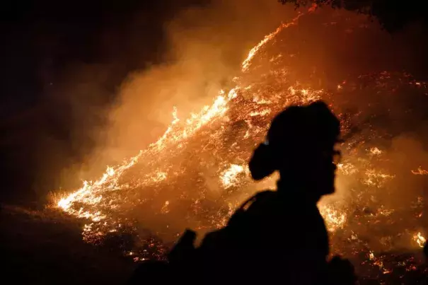 Firefighters stand watch by a fire line along Mayacama Club Drive as the Kincade Fire burns in the outskirts of Santa Rosa, Calif., on Oct. 28, 2019. Credit: Dai Sugano/Bay Area News Group