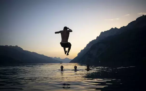 French emergency services are urging bathers to enter water gradually to avoid potential deadly 'thermic shock' to the body, which can shut down due to rapid temperature changes. Credit: Rex, Gian Ehrenzeller, EPA